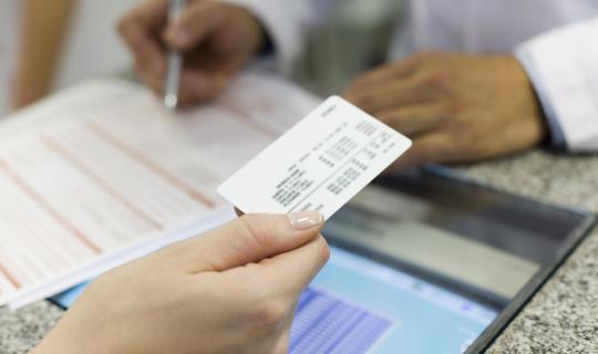 insurance card and tablet